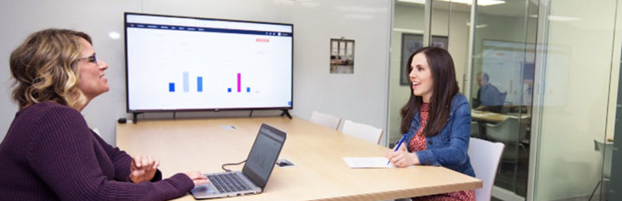 Two women in a conference room having a discussion